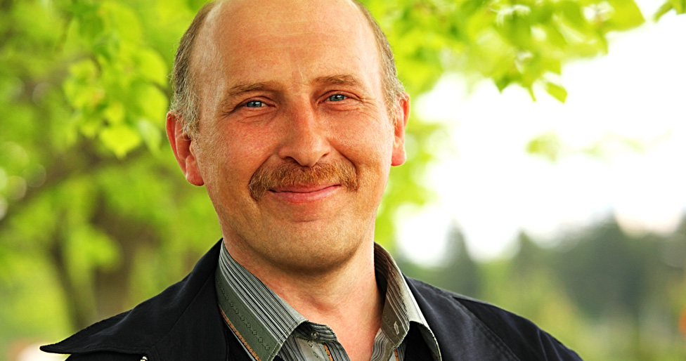 Middle-aged man with a smirk.