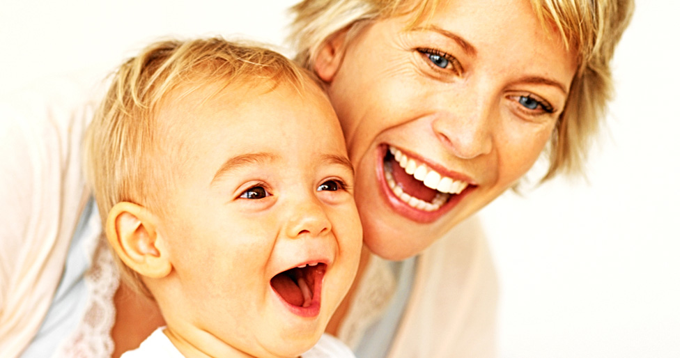 Mother and child smiling together.